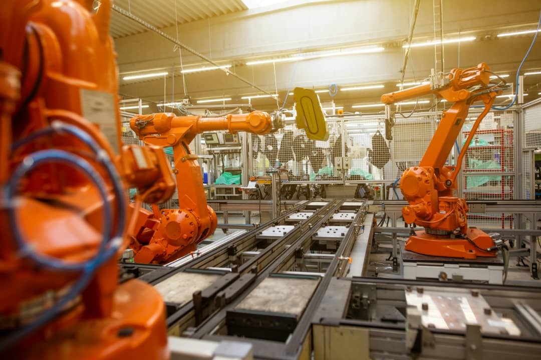 Industrial robotic arms on a modern manufacturing production line